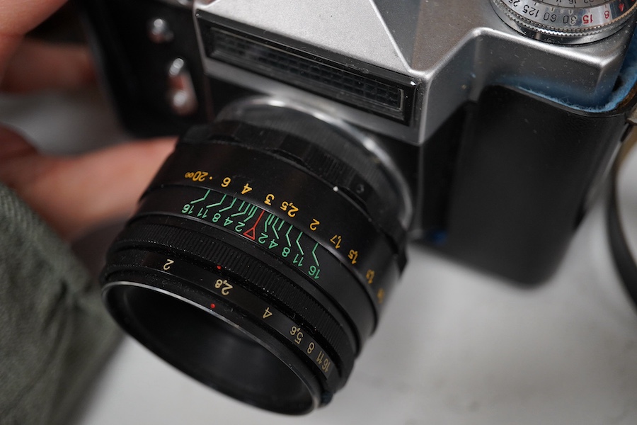 A Leica Model II camera in its original leather case, No. 204618, together with four additional cameras; a Zeiss Ikonta, a Zeiss Nettar, a Prinzflex 500E, and an Ensign Midget camera in its original card box with instruc